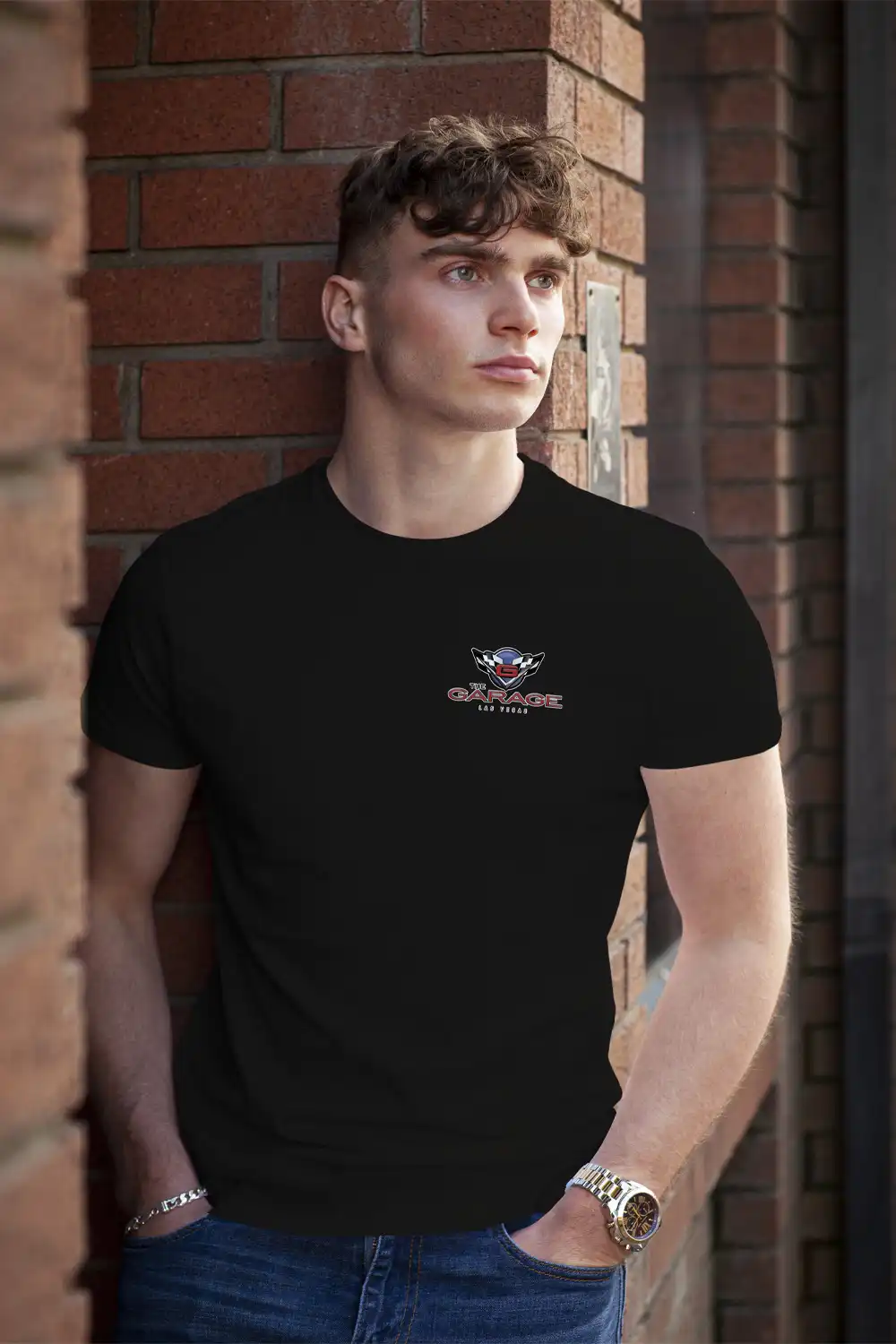 Handsome guy modeling a black T-shirt with The Garage Las Vegas logo